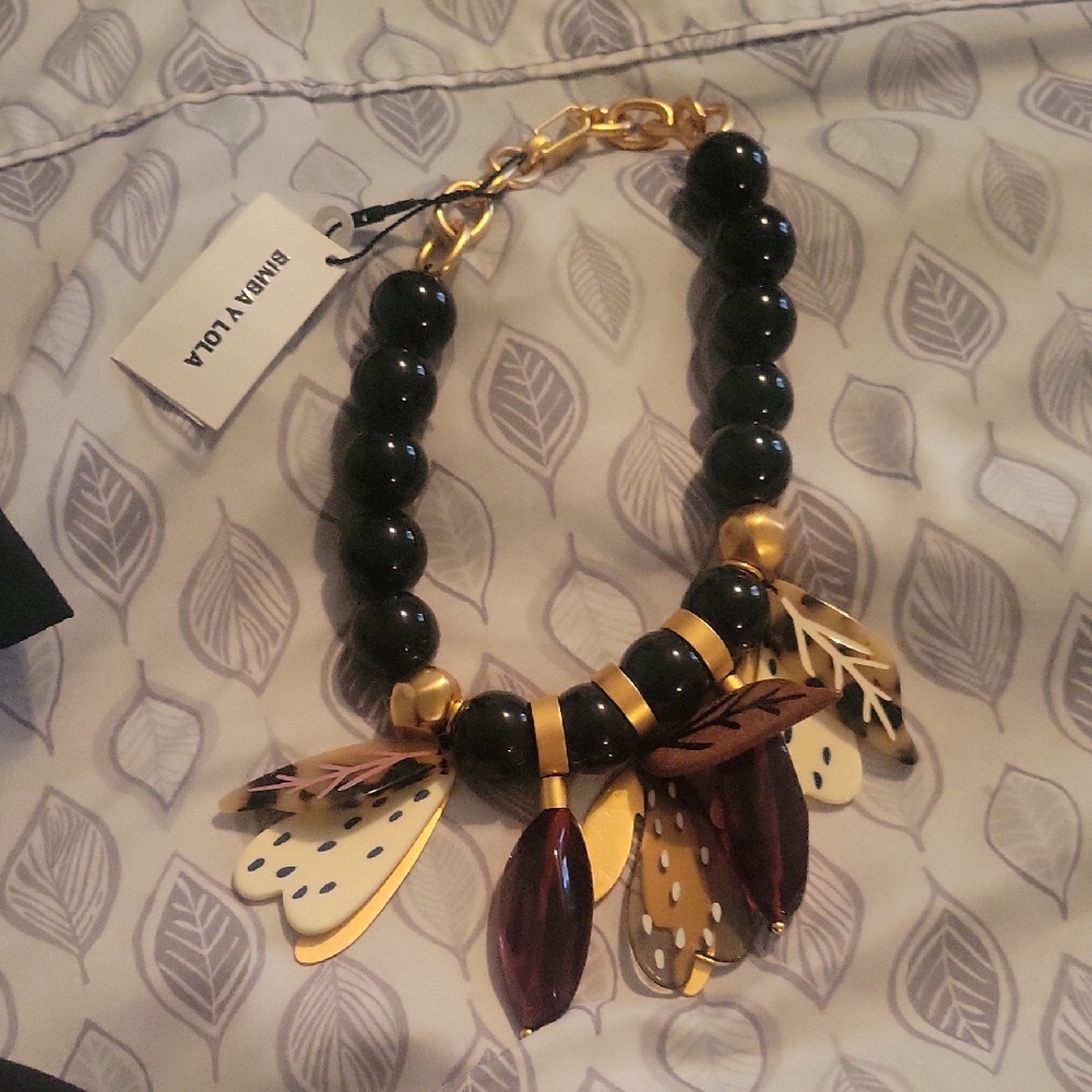 Elegant Black and Gold Necklace with Nature-Inspired Charms